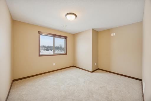 Spacious lower-level flex room or non-conforming 6th bedroom, offering flexibility as a workout room, playroom, or additional space.