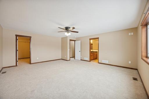 Alternate view of the primary bedroom highlighting the private ensuite access and walk-in closet.