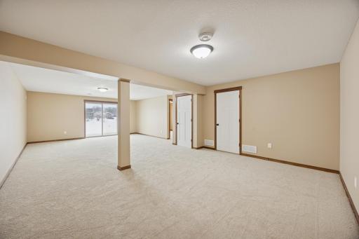 Another view of the expansive lower-level living space offering flexibility for multiple seating or activity areas.