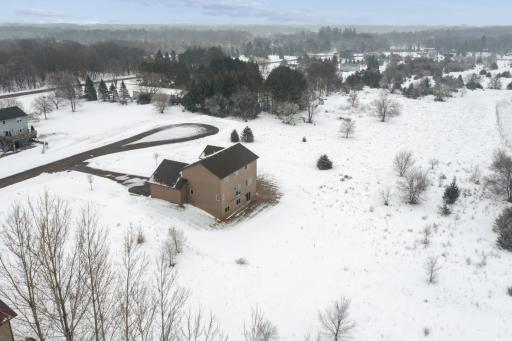 Aerial view highlighting the homeâs setting within a quiet neighborhood and surrounding natural landscape.