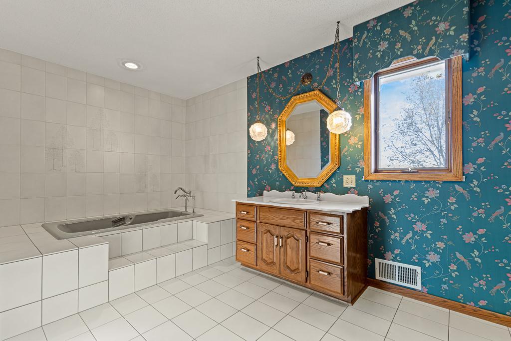 Large primary suite bathroom showcasing soaking tub, and generous space designed for everyday comfort.