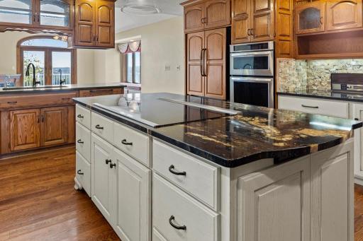 Oversized center island with striking stone countertops, abundant storage, and the perfect gathering space for cooking and entertaining.