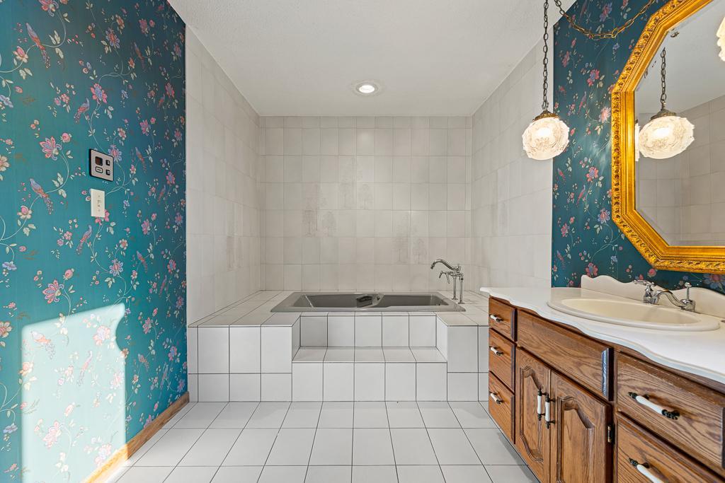 Relaxing soaking tub creates a spa-inspired retreat within the spacious primary bathroom.