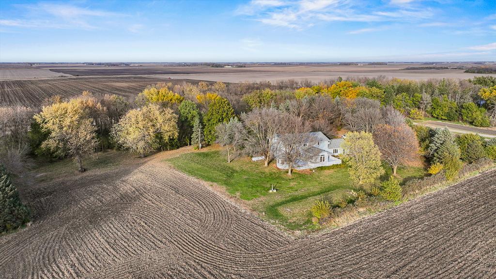 Private 5-acre setting surrounded by mature trees and open countryside views, offering space, privacy, and peaceful country living