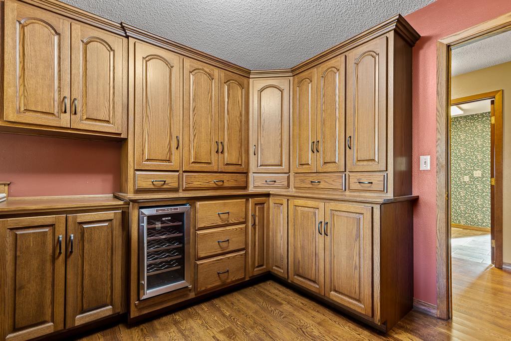 Well-appointed butler’s pantry showcasing custom cabinetry, beverage fridge, expansive prep areas, and abundant storage for effortless entertaining.