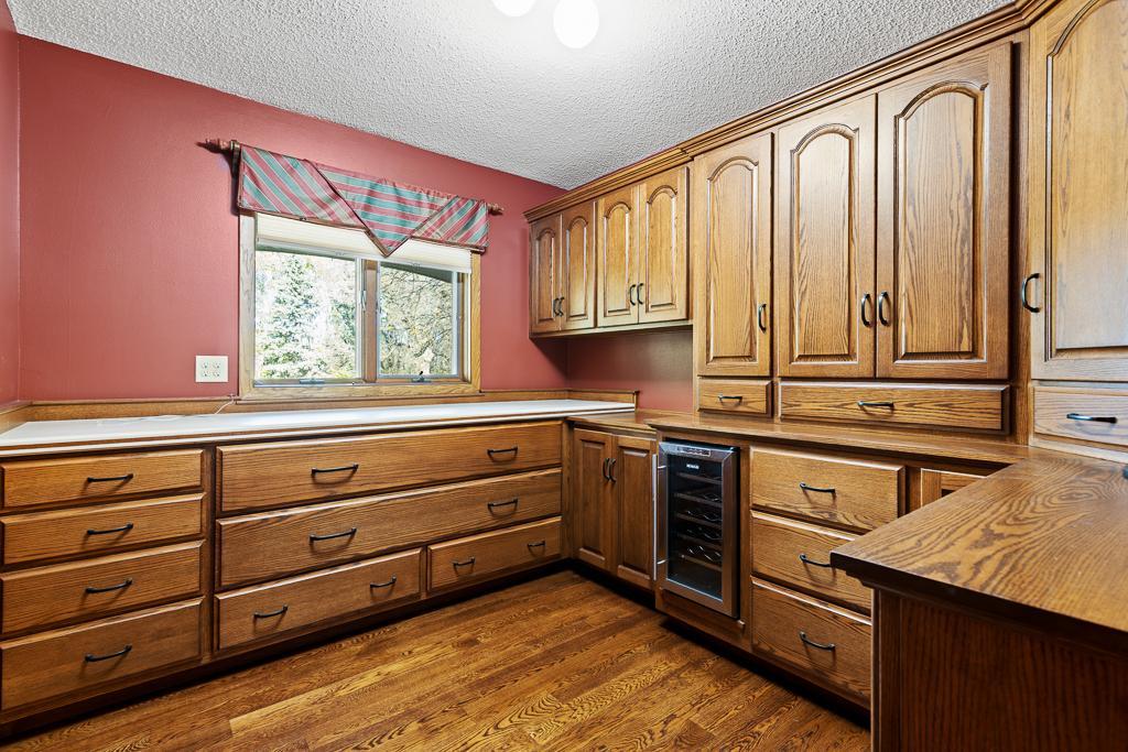 Custom butler’s pantry with floor-to-ceiling cabinetry, built-in beverage refrigerator, and generous storage and prep space.