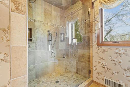 Beautiful walk-in tiled shower with glass enclosure and natural light creating a spa-inspired feel.