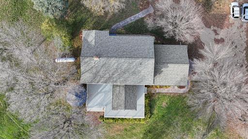 Aerial perspective showcases the thoughtfully positioned home site surrounded by established trees and natural privacy.