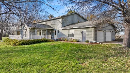 Versatile acreage lifestyle with extensive outdoor living space, attached oversized garage, and room to enjoy hobbies, recreation, and storage.