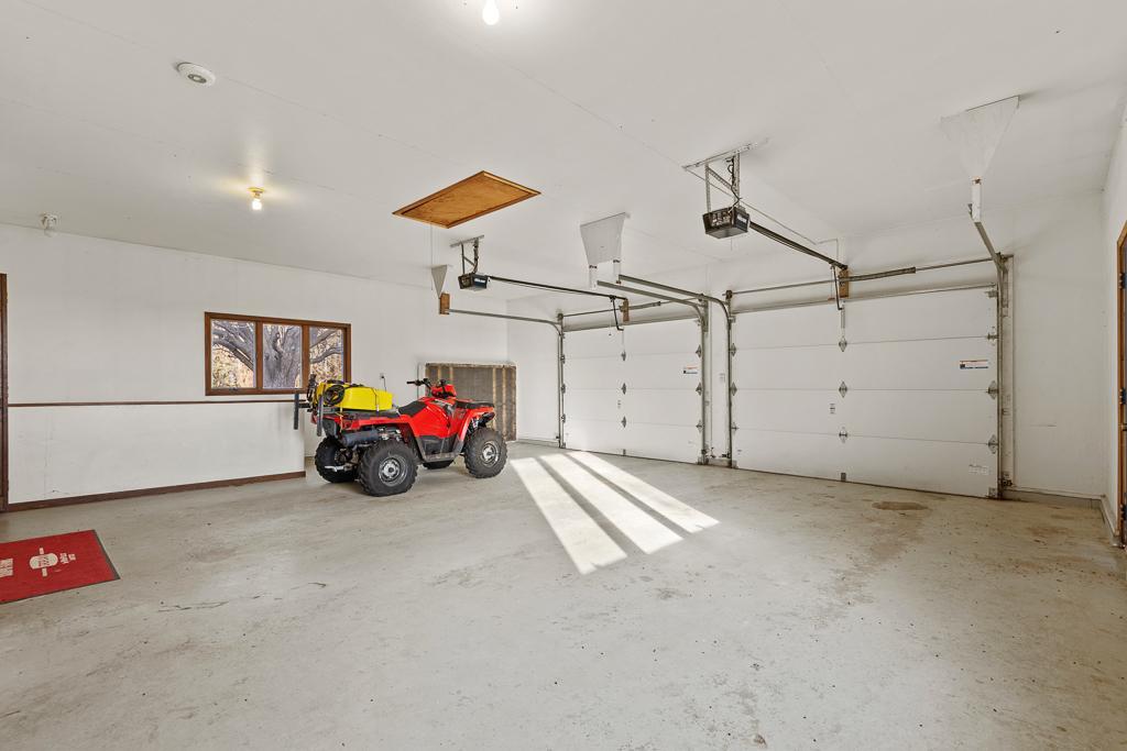Extra-large insulated garage with oversized bays, high ceilings, abundant storage potential, and room for vehicles, toys, equipment, and workshop space.