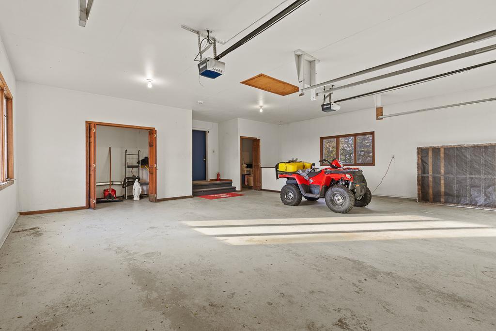 Spacious oversized garage designed for functionality with generous workspace, multiple vehicle capacity, easy access, and ample room for recreational storage and hobbies.