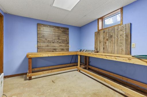 Dedicated workshop with built-in workbenches and versatile space for hobbies, projects, tools, crafts, or additional storage