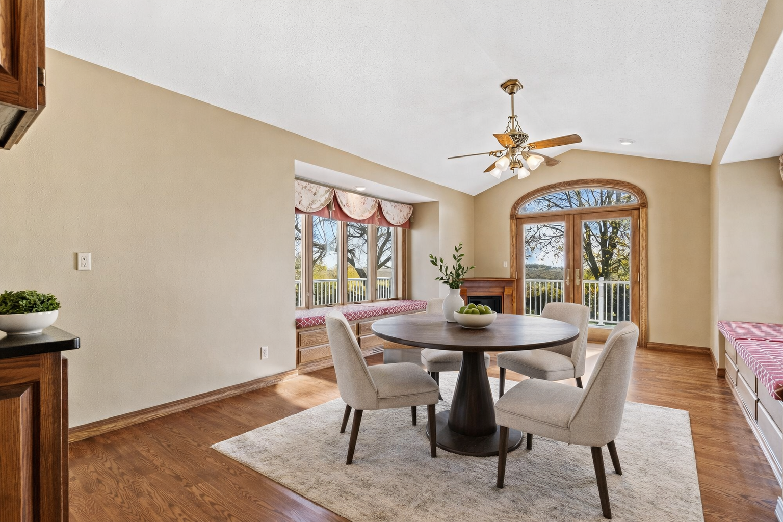 Charming breakfast nook/dinette with built-in window benches, hardwood floors, and open flow to the kitchen—perfect for casual dining and entertaining. virtually staged