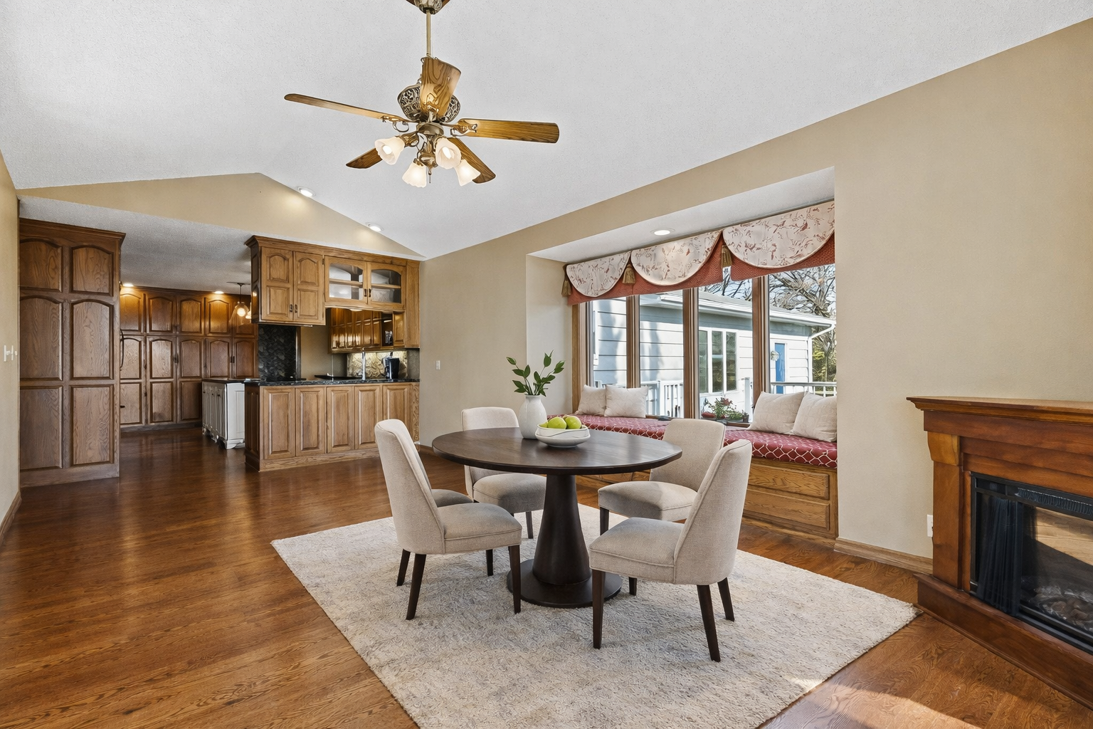 Sun-filled dinette/breakfast area with charming built-in window benches offers the perfect spot for everyday meals or morning coffee. This inviting space flows seamlessly into the kitchen and features hardwood floors, abundant natural light.