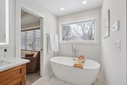 Freestanding soaking tub creating a calm, spa-like retreat in the primary bath.