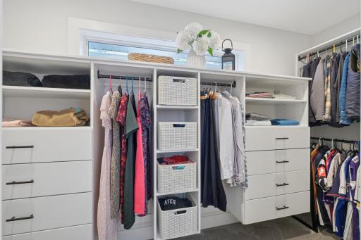 Large walk-in closet with custom built-in storage systems.