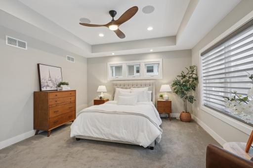 Primary bedroom featuring custom Hunter Douglas automated window treatments for effortless light and privacy control.