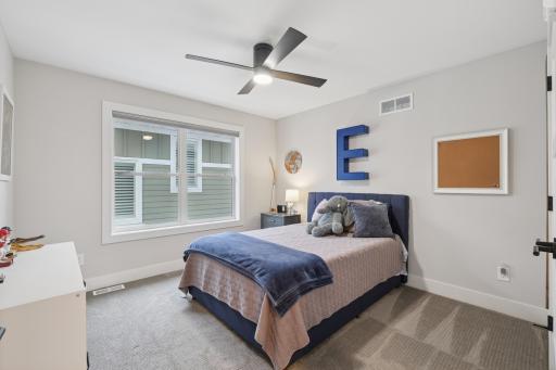 Secondary bedroom with ceiling fan and ample closet space.