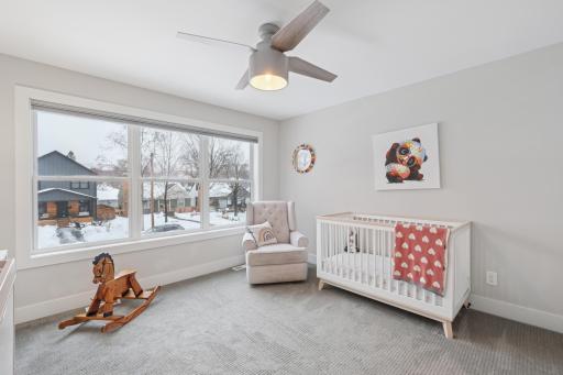 Additional upper-level bedroom with custom Hunter Douglas motorized blinds, ideal for guest room, nursery, or office.
