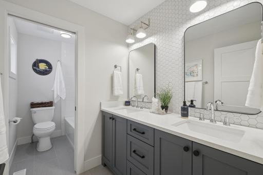 Full upper-level bathroom with modern finishes and heated floors.