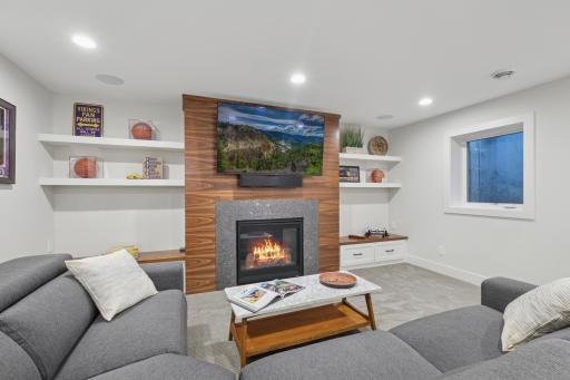 Custom entertainment wall with gas fireplace, built-ins, and mounted TV area.