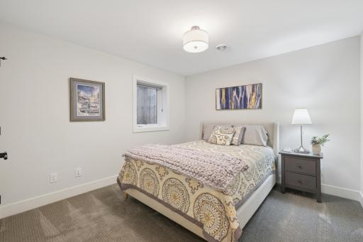 Lower-level bedroom with generous space and neutral finishes.
