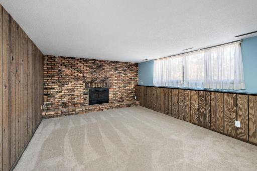 Lower level family room has lots of natural light and a cozy gas fireplace. Just click the remote and enjoy!