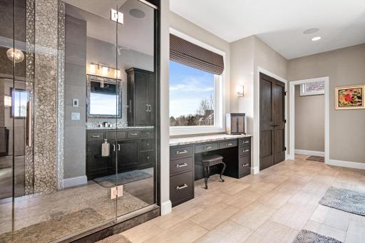 Primary bathroom complete with vanity station and oversized shower with dual shower heads.