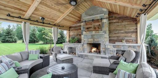 Outdoor pavilion with paver & blue stone flooring. Stone wood-burning fireplace. Two 220V infrared heaters. TV cabinet with sliding barn doors. Lutron-controlled dimmable lighting. Electrical sub-panel installed and wired for future swimming pool.