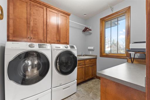 Main Level Laundry Room with sink and folding counter