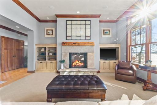 Oversized gas fireplace with stone surround, custom mantel and built ins.