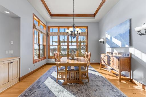 Spacious dining room with box vaulted ceiling and expansive lake views!