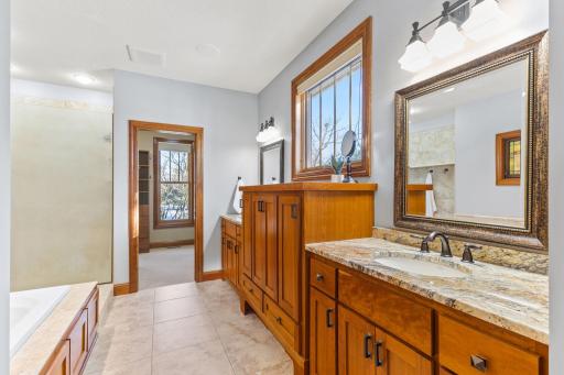 Custom cabinetry in ensuite with granite counters and double sinks