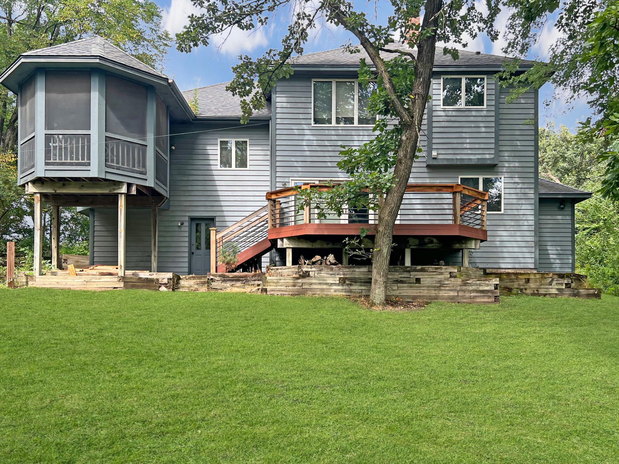 Back of the home view with screened porch, back deck and green space!