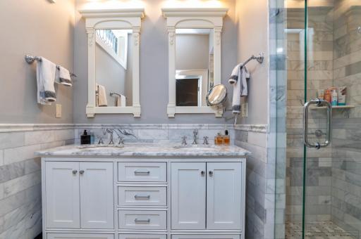 The primary bathroom has been updated with classic details like marble tiling.
