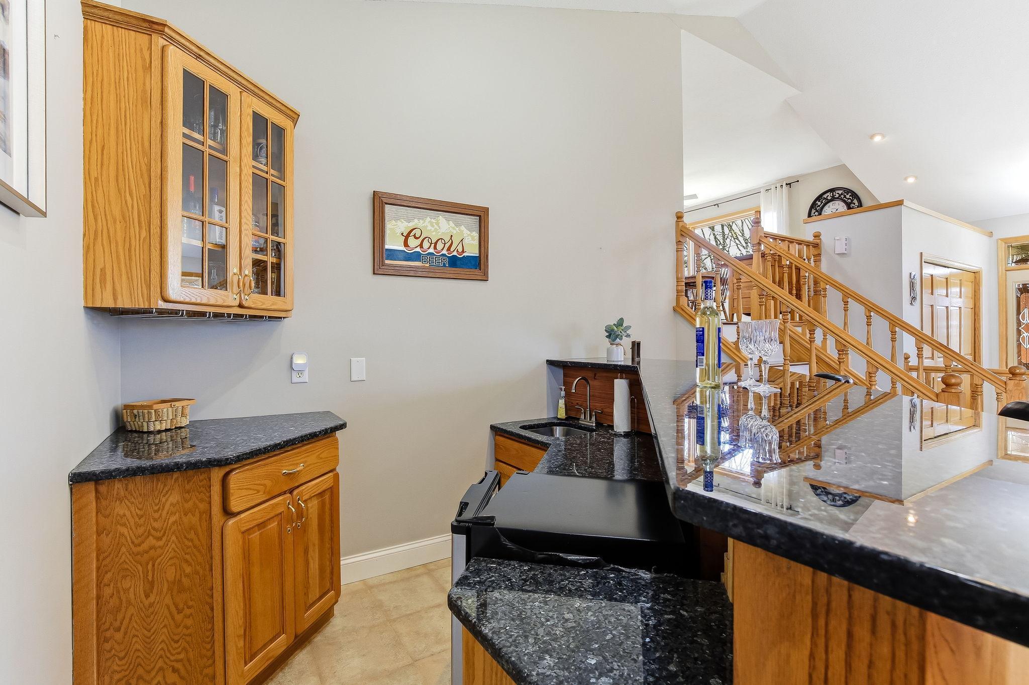 Convenient bar area just off the main living space with seating and storage.