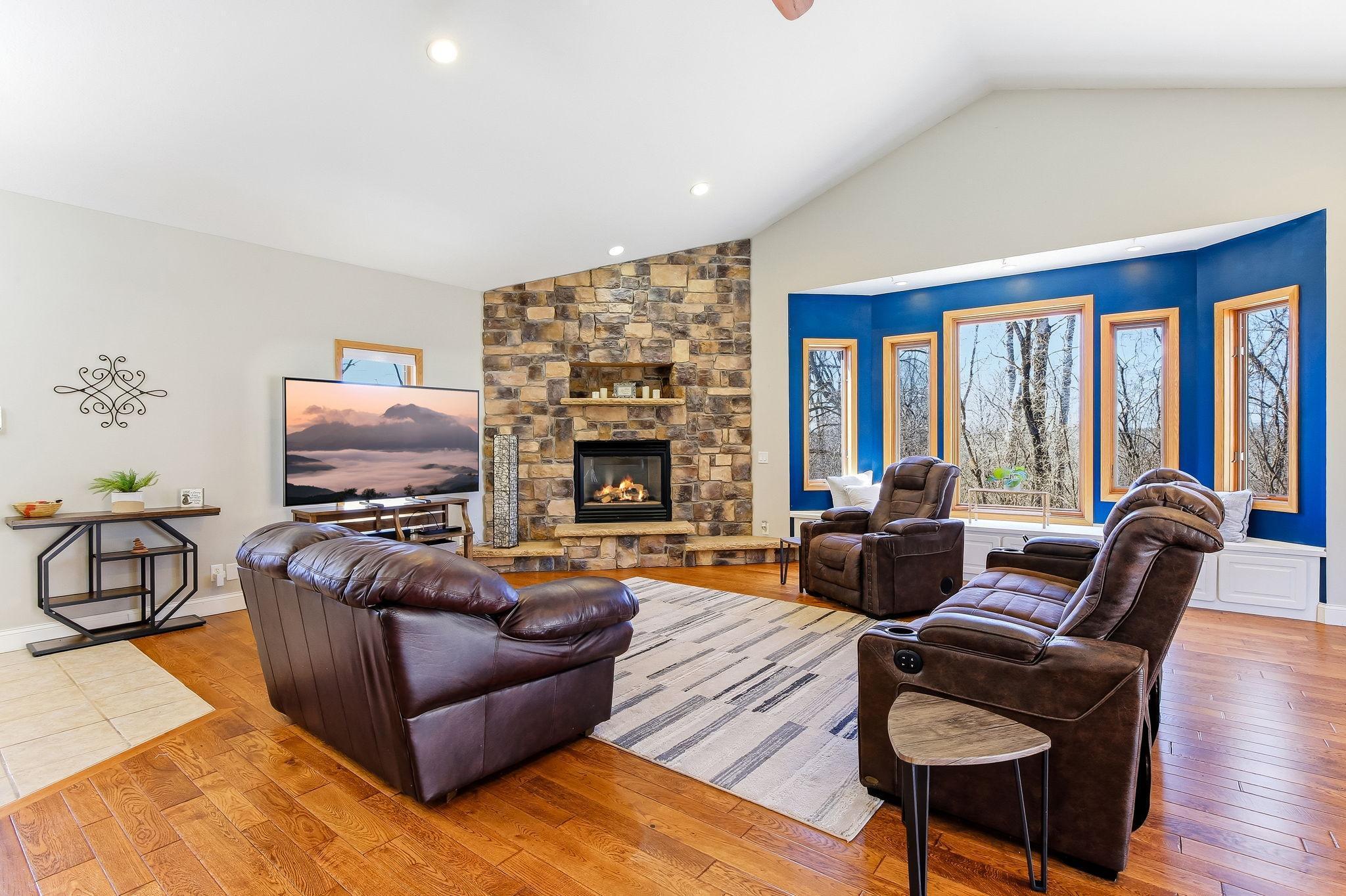 Full wall stone Fireplace creates a strong focal point in the vaulted Great Room.