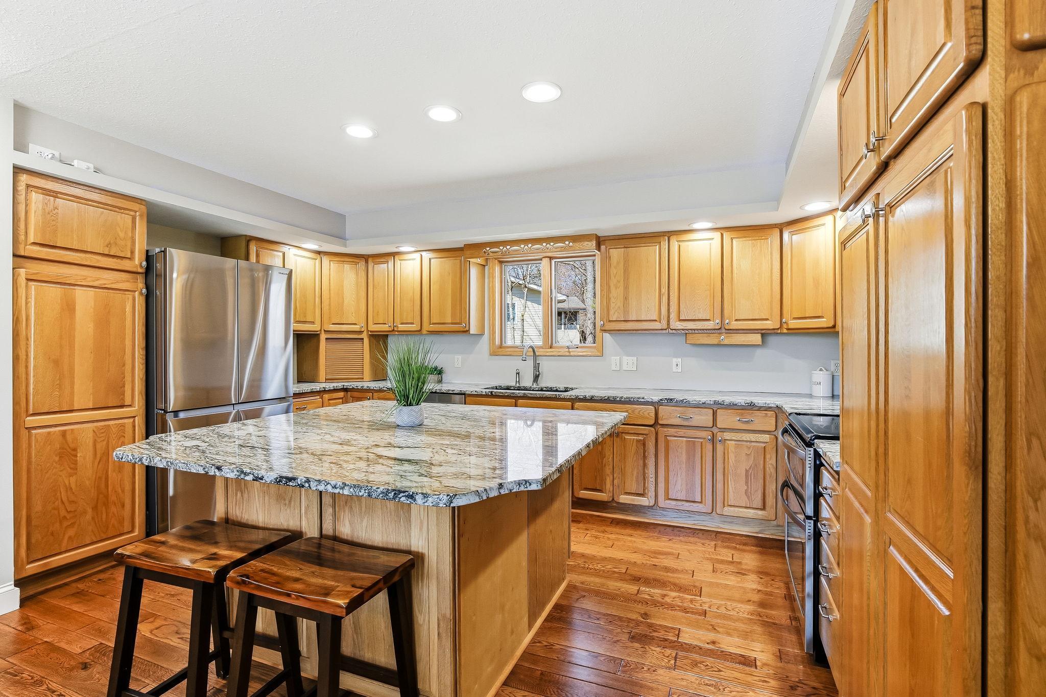 Large Kitchen with granite countertops, island seating, and plenty of cabinet space.