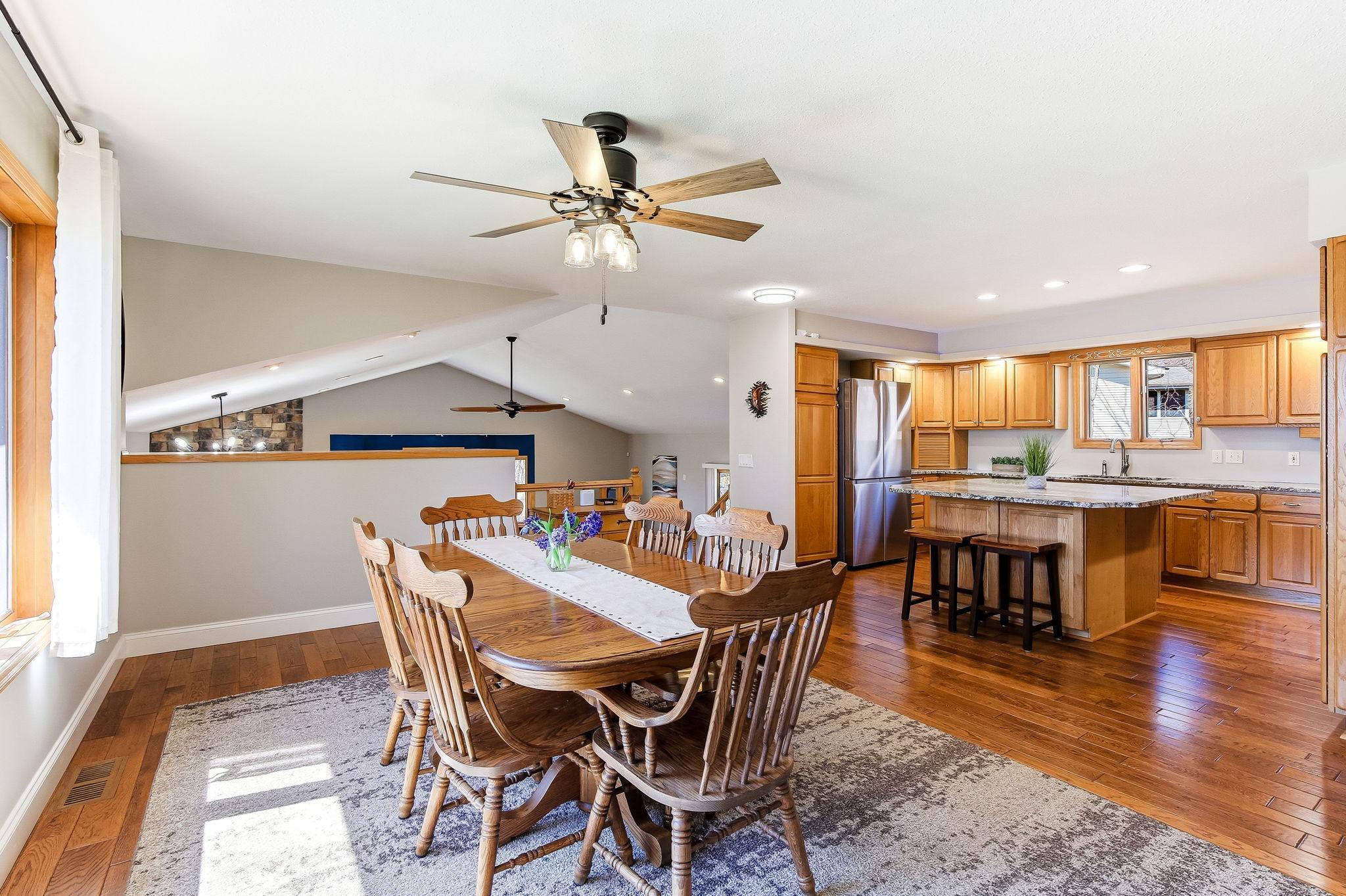 Kitchen with granite, large island, stainless appliances, and open Dining area.