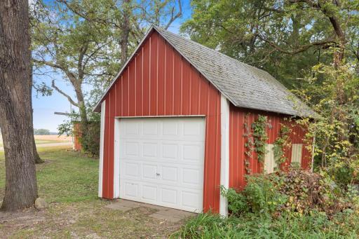 Single-stall detached garage with cement flooring and a convenient garage door opener.