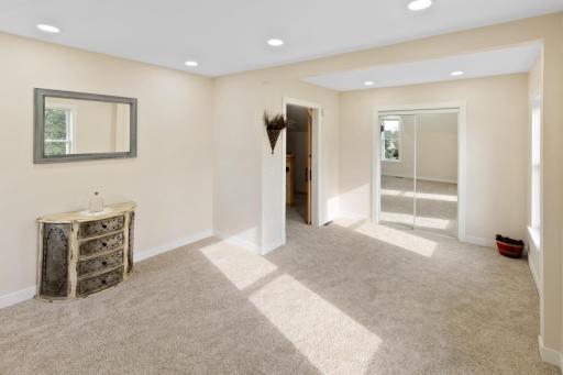 This oversized upstairs bedroom, once two rooms combined, now offers ample space for a large bed and sitting area. The thoughtfully designed closet provides maximum storage.