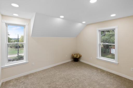 Upstairs bedroom with windows on the south and west sides, filling the space with warm natural light from sunrise to sunset.