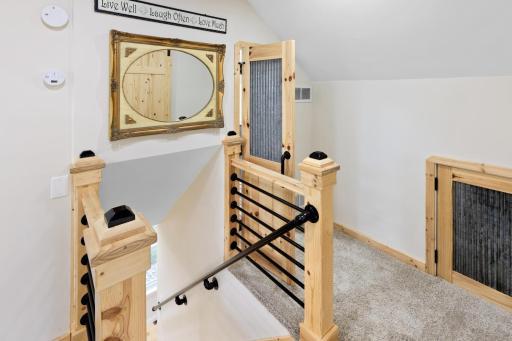 Even the upstairs staircase was handcrafted with the finest detail, enhancing this 1900s home with a modern, clean feel. Storage access to the right provides ample space, or the option to finish it into a fun play area for kids.