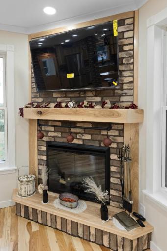 Handcrafted fireplace with rich tile detail and a custom mantel, serving as a stunning focal point in the living room and the ideal spot to gather on cool evenings
