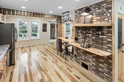 Beautiful hickory floors throughout, paired with grouted Koni brick, add warmth and natural charm—bringing the outdoors in and enhancing the home’s inviting character.