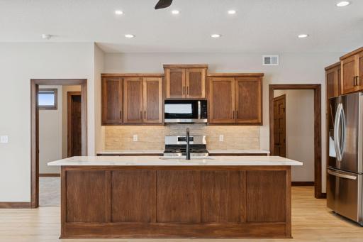 Kitchen has custom cabinetry and quartz countertops