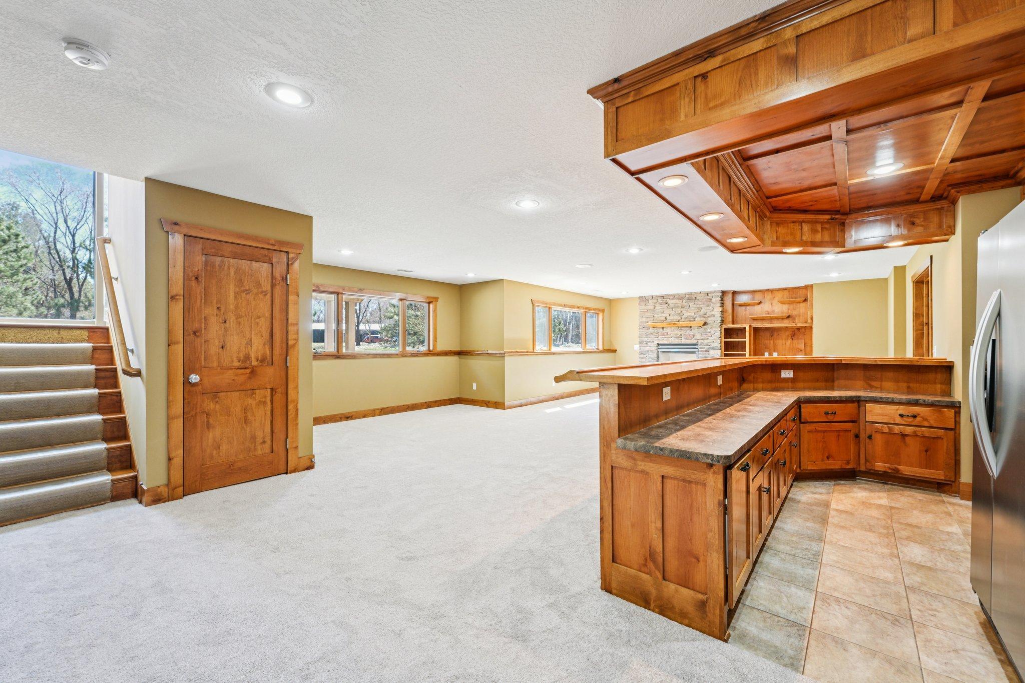 The lower level is loaded with natural light, and brings a second huge family room/living space in the lower level, and check out that wet bar!