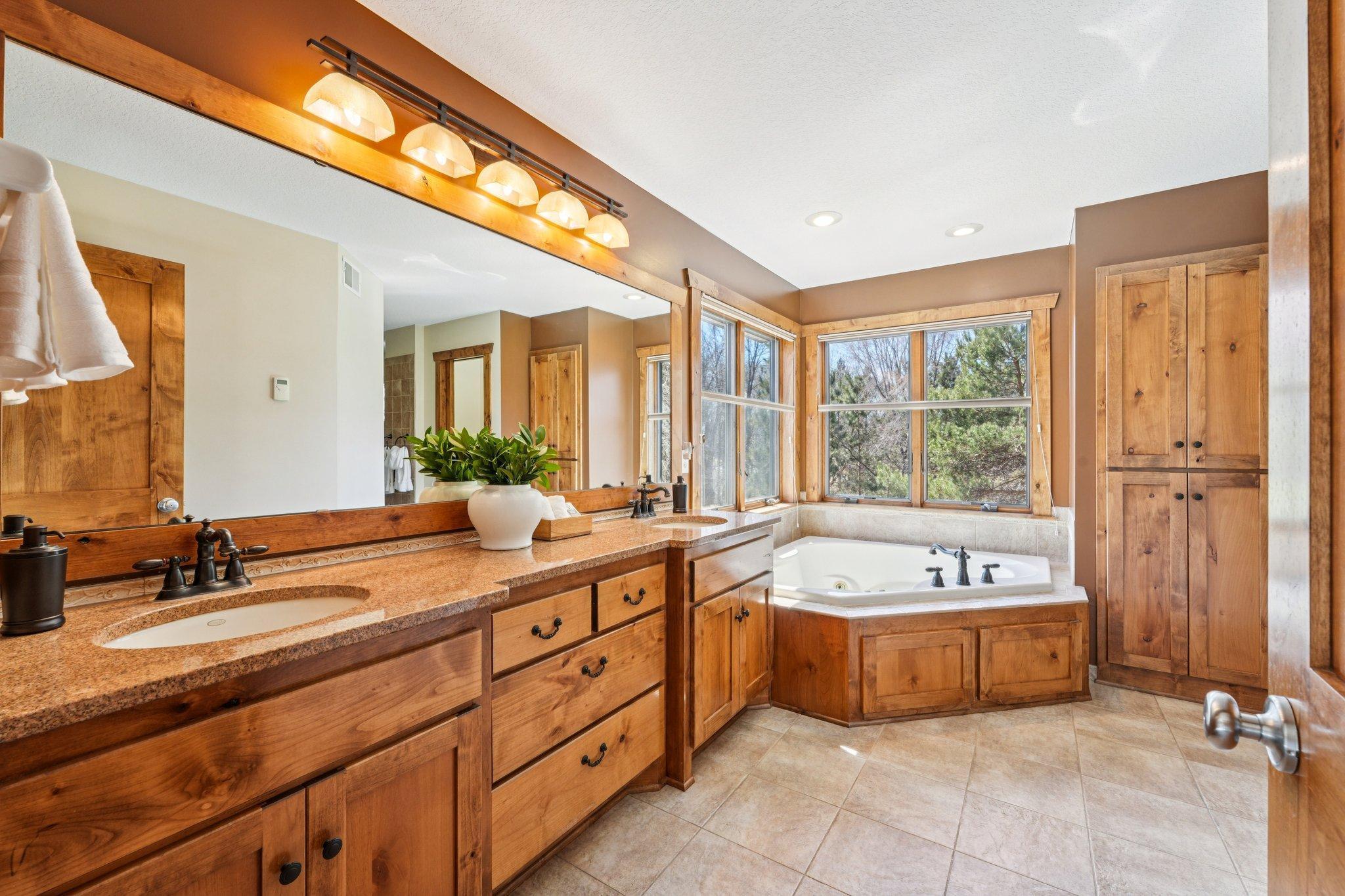 Primary bath with heated floors, double vanity, jetted tub and walk-in shower stall