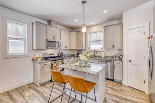 The kitchen features a center island, stainless steel appliances, granite countertops, and a large walk in pantry.