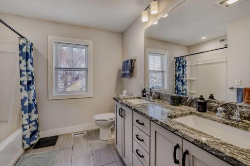 The bathroom has natural light and a full shower/bath.